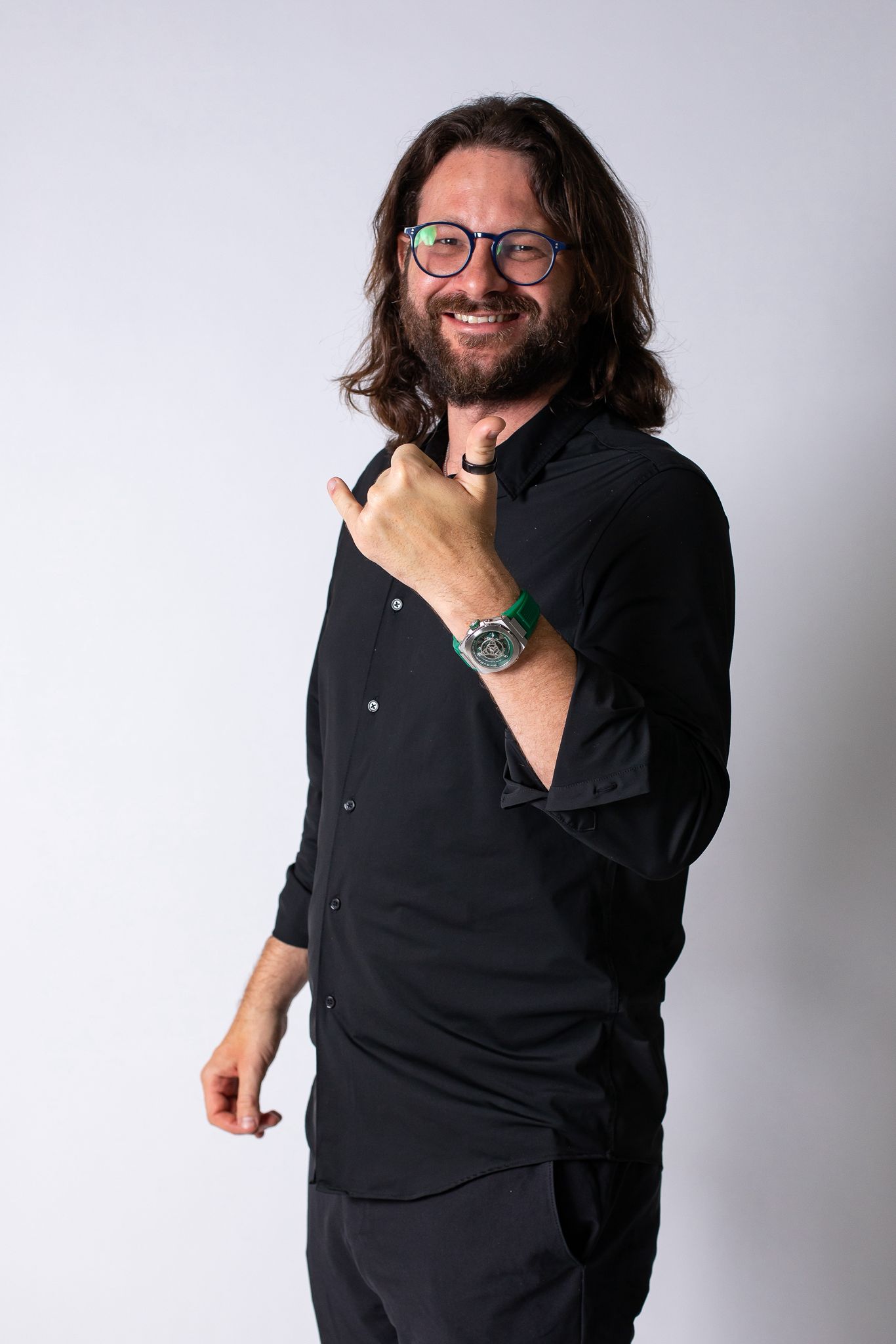 Miguel Lannes, known as Inventor Miguel, smiling in a black shirt and green watch.